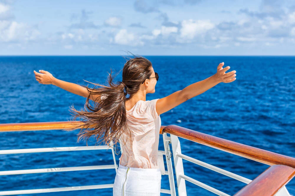 Cruise ship vacation woman enjoying travel vacation at sea.