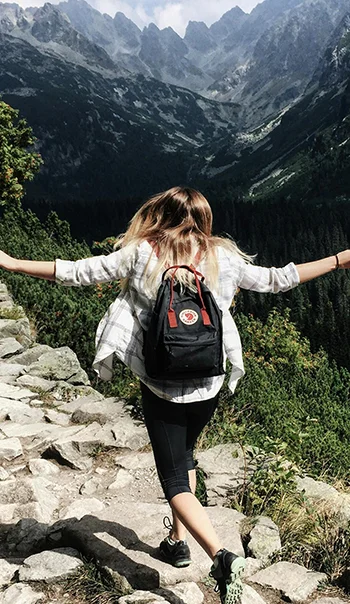 Woman Standing on Cliff